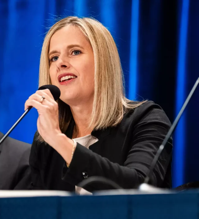 Woman speaking into microphone